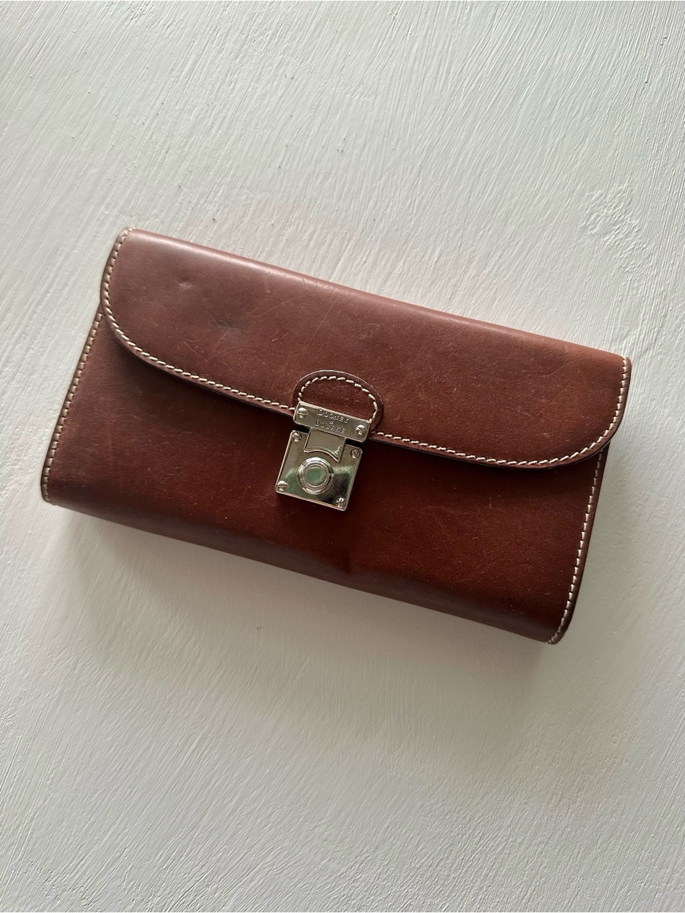 Dooney & Bourke Alto Pushlock Clutch Wallet in a brown leather finish